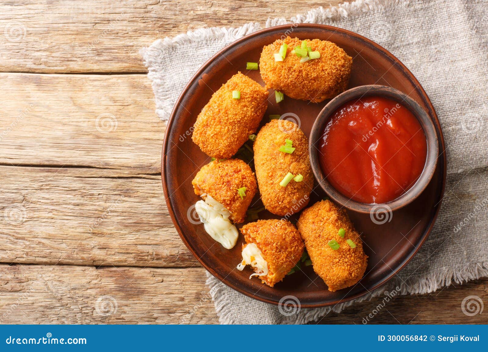 suppli al telefono are made with a simple sauce, rice and fresh mozzarella closeup on the plate on the table. horizontal top view