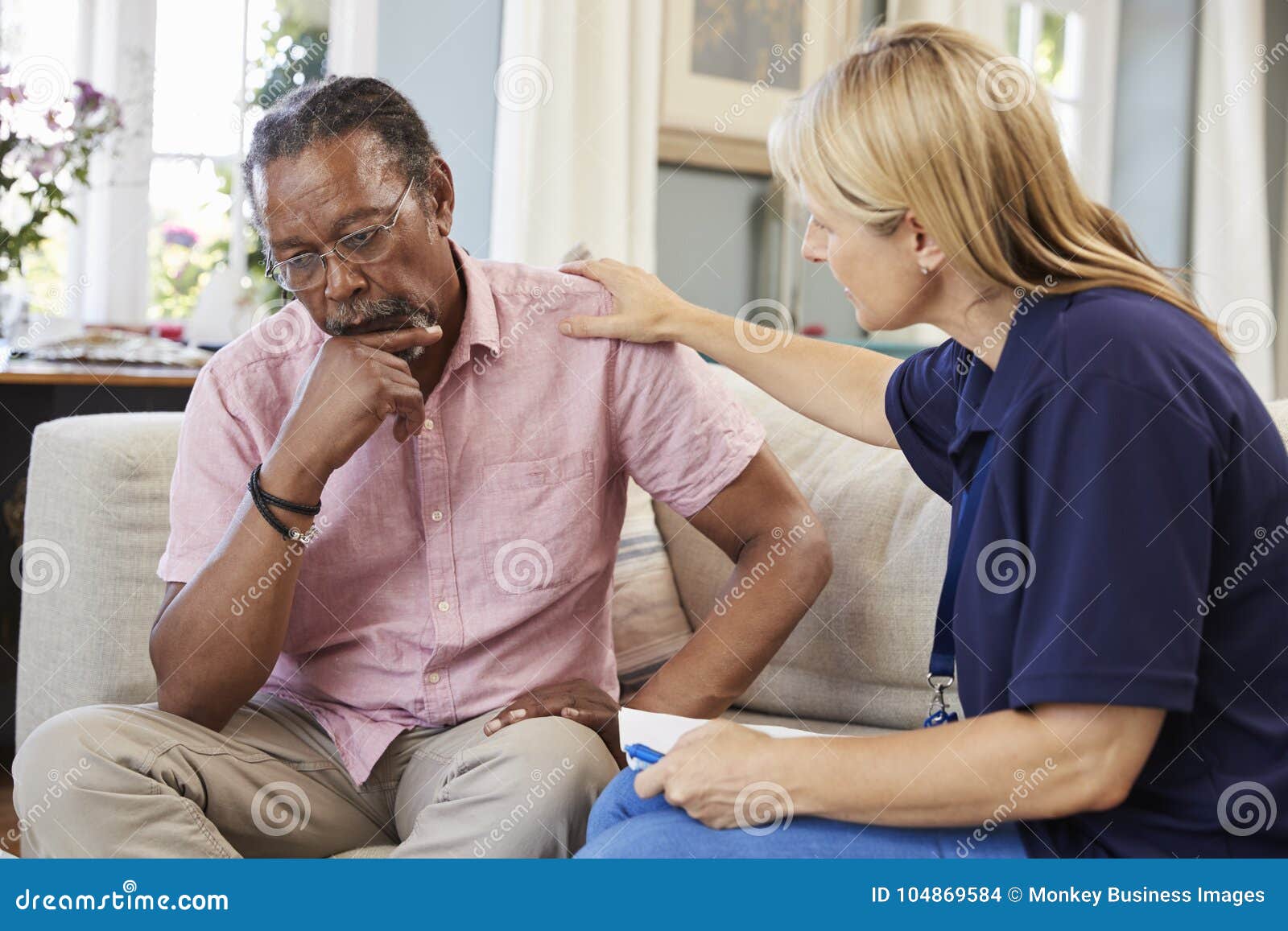 support worker visits senior man suffering with depression