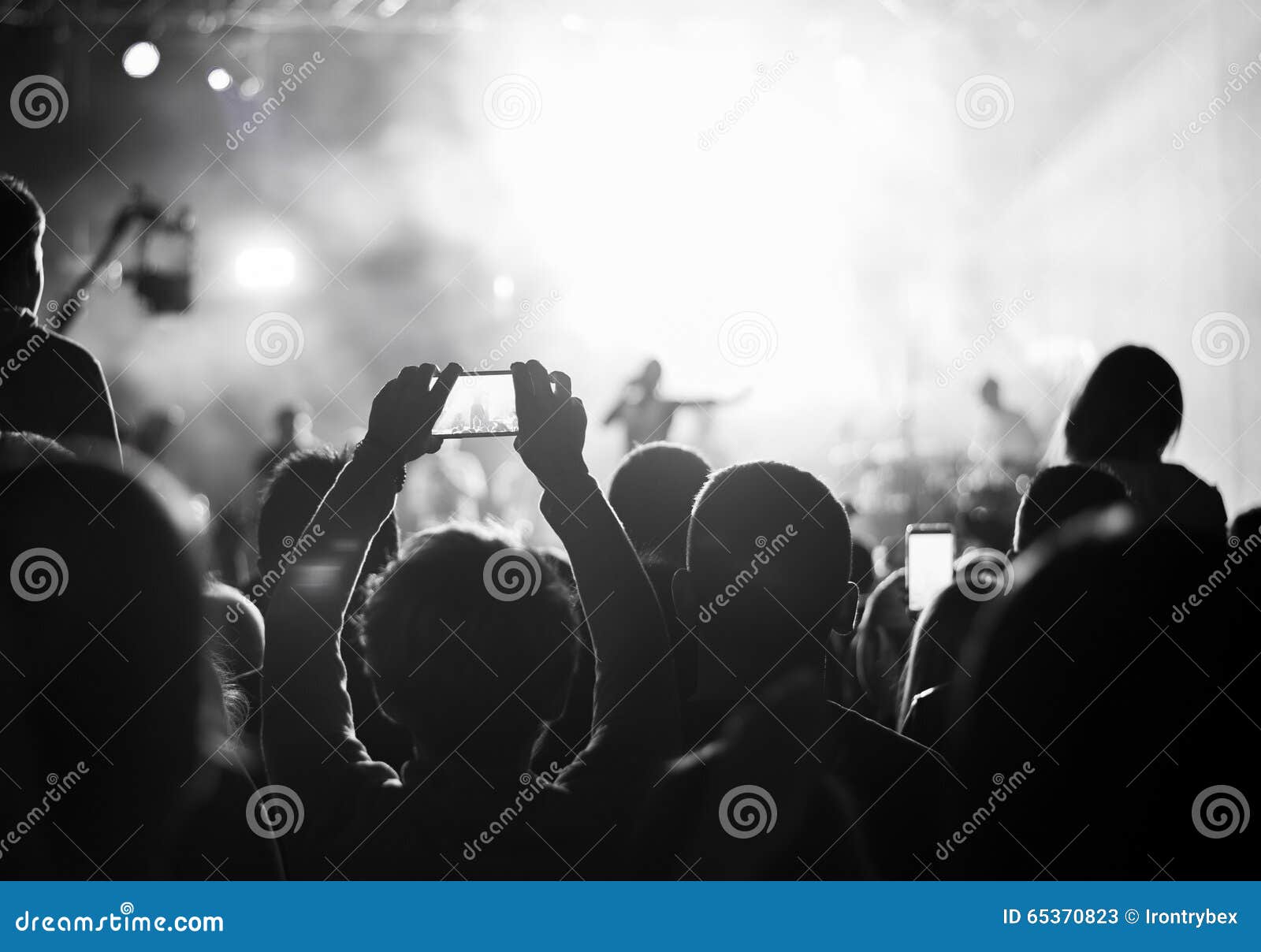 supporters recording at concert, black and white