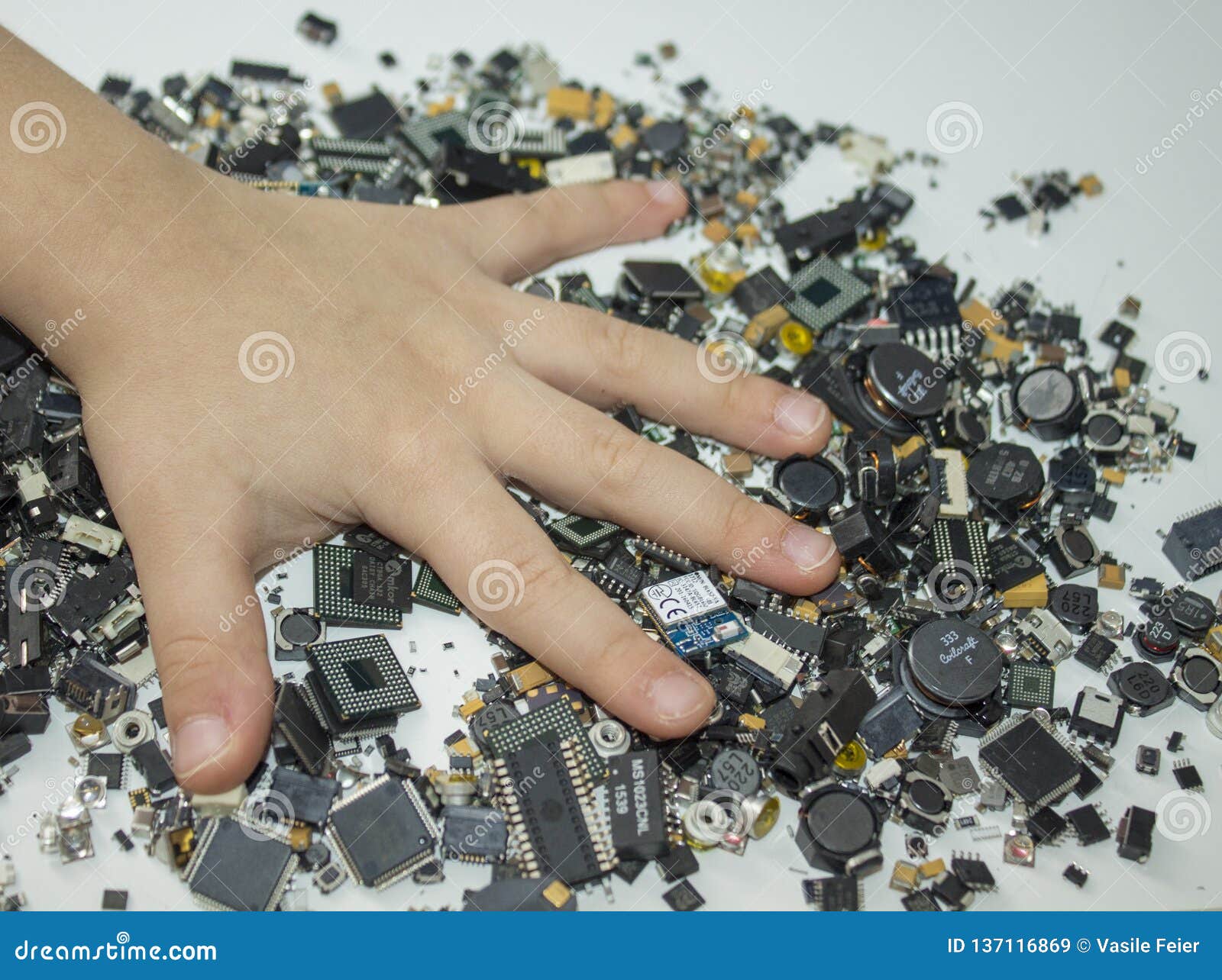 smt components and a child hand over them.