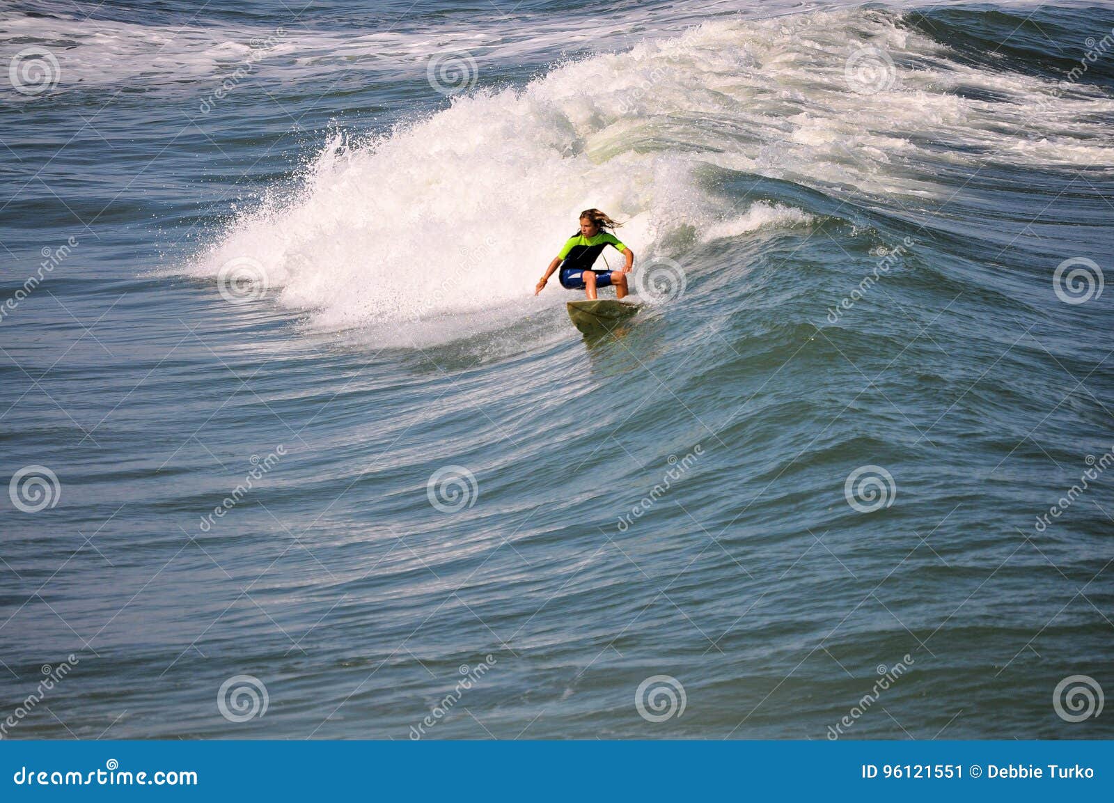 surfer boy carving a wave in the outer banks of nc