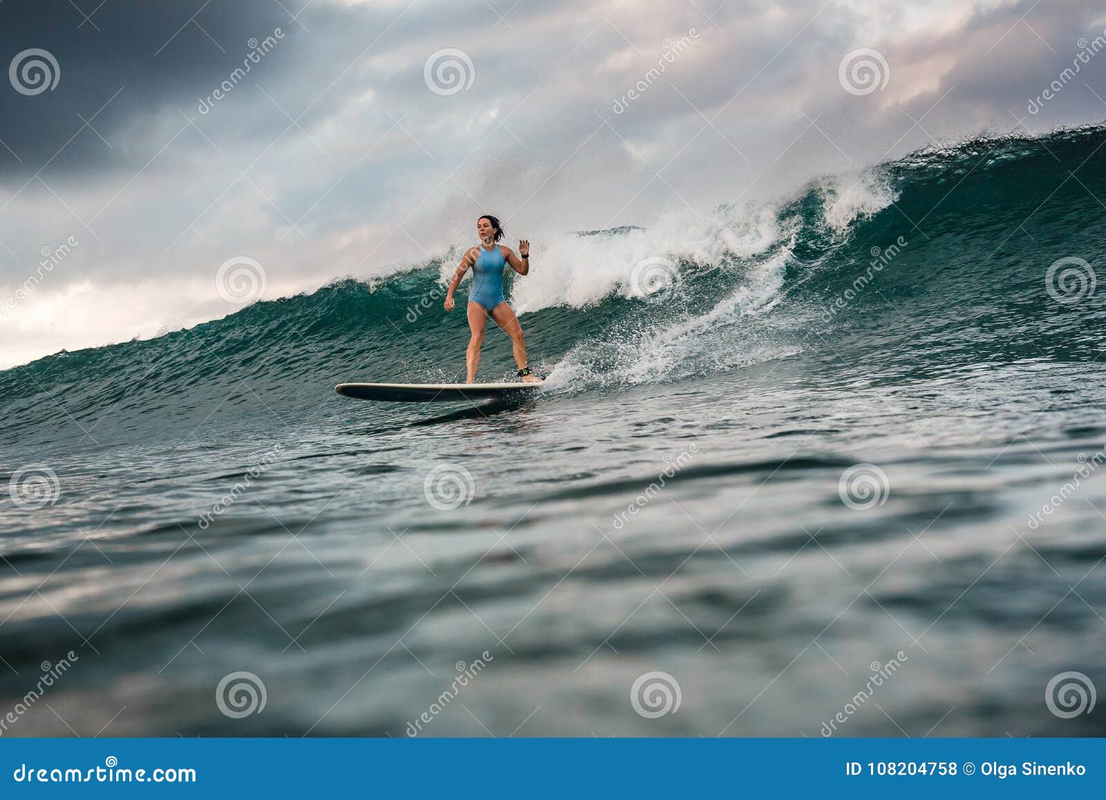 Young Woman In Bright Bikini Surfing On A Board In Ocean Stock Photo ...