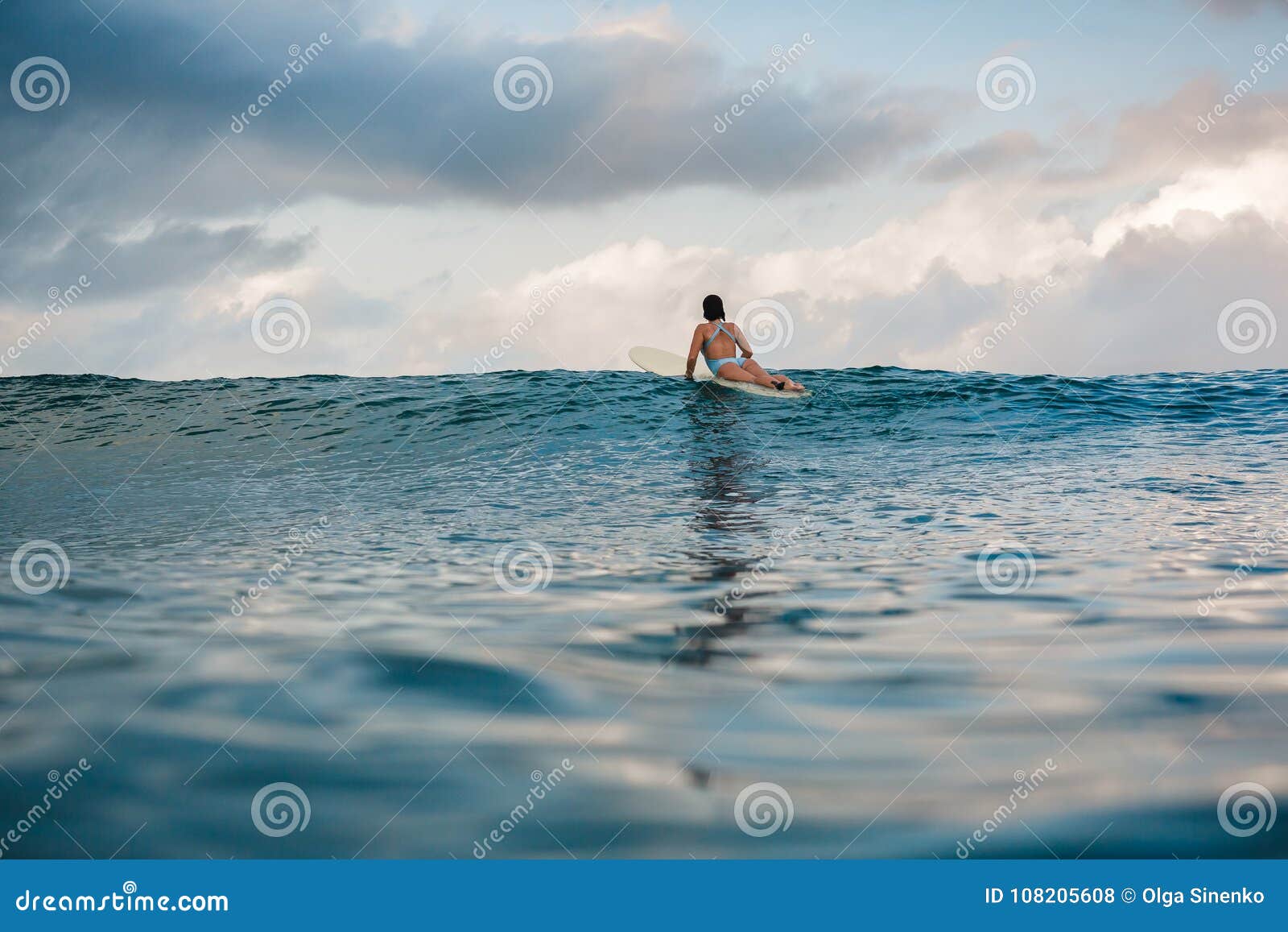 Young Woman in Bright Bikini Surfing on a Board in Ocean Stock Photo ...