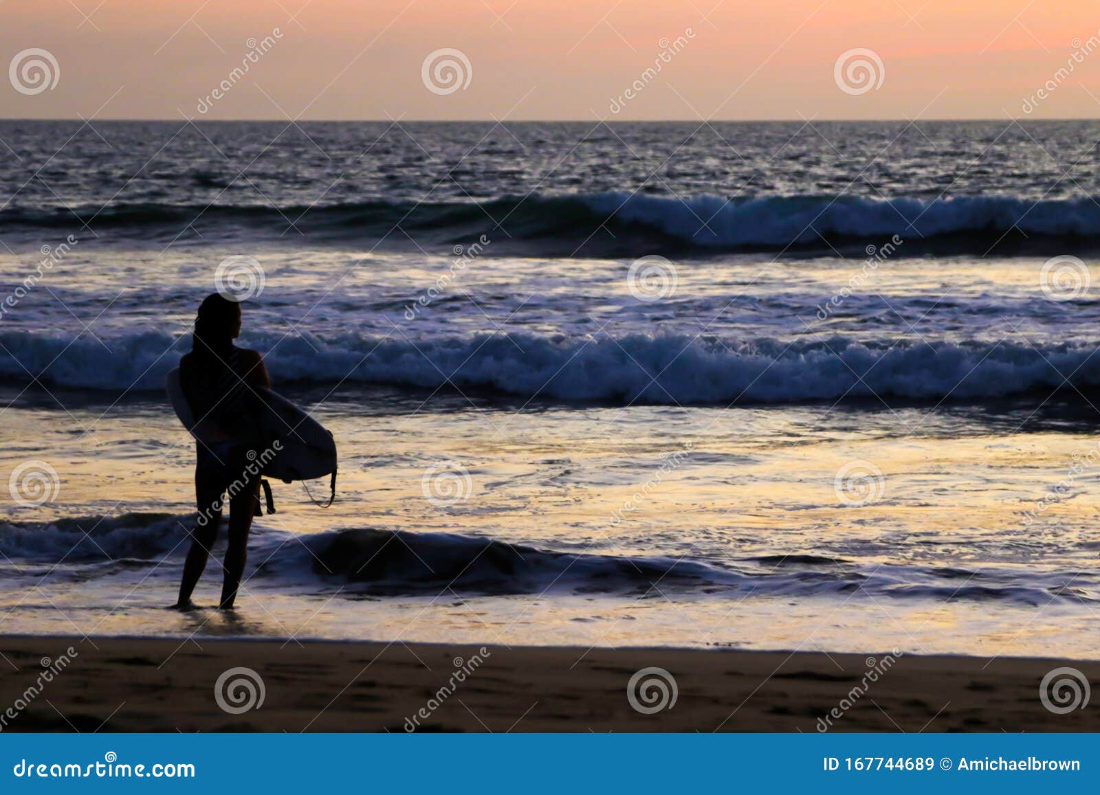 a surfer girl at sunset.