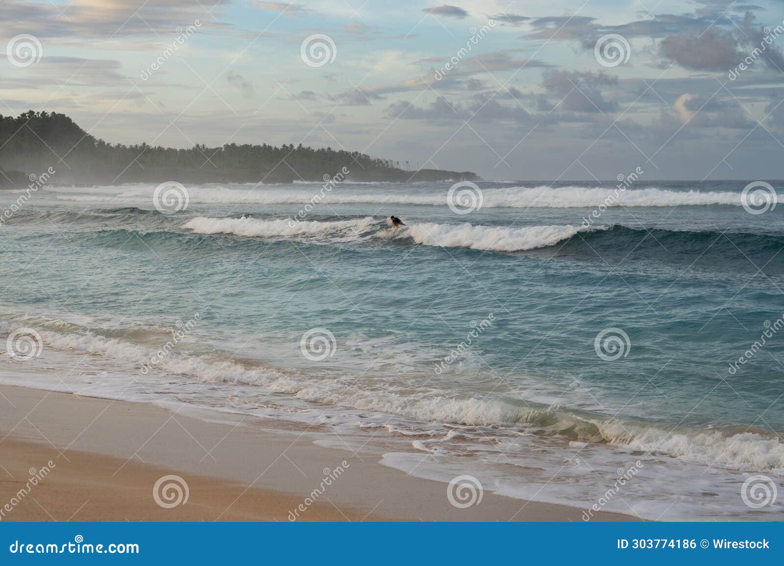 surfer at pacifico beach, siargao, philippines