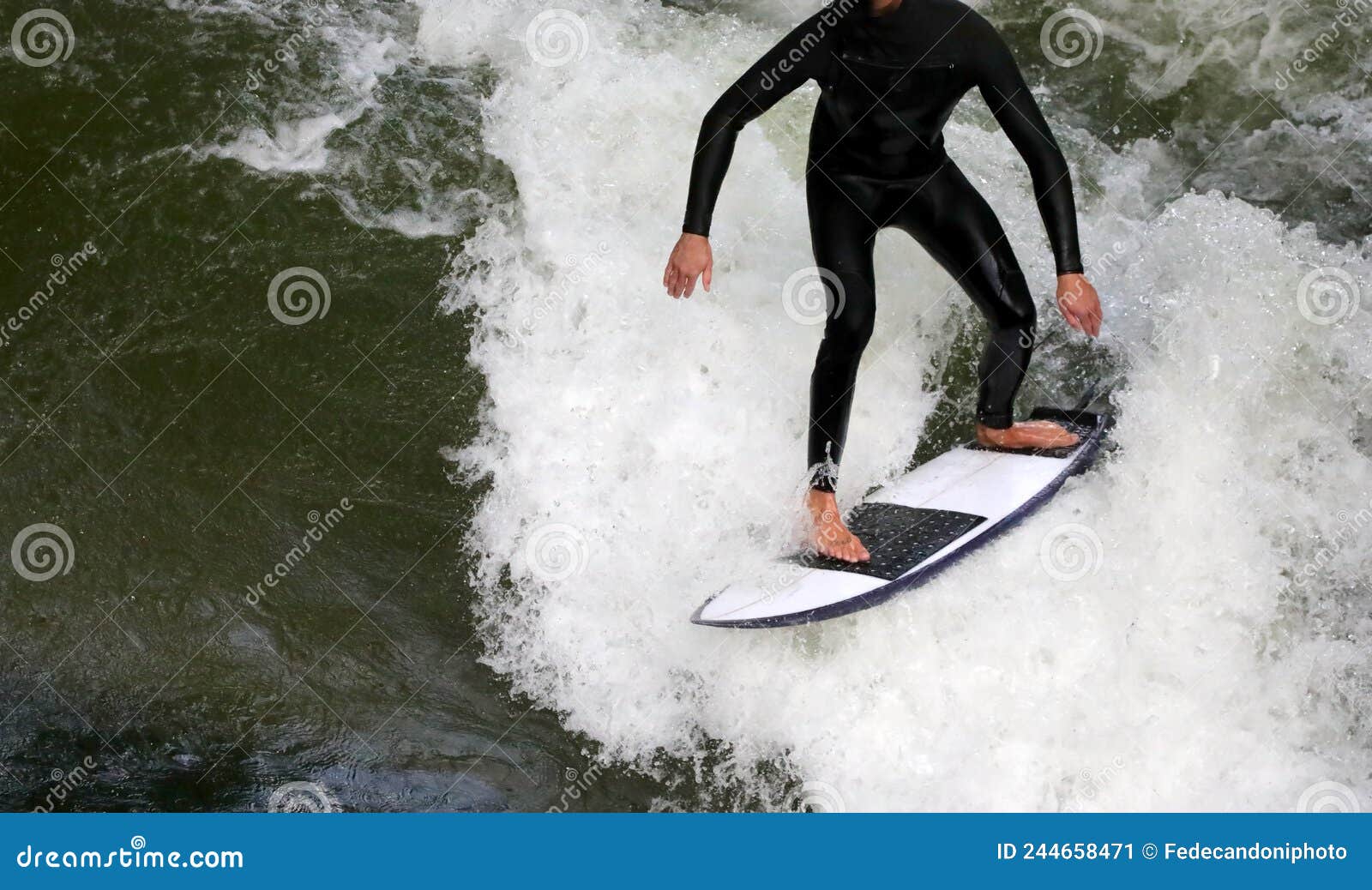 Surfer with Surfboard while Riding the Wave while Remaining Perf Stock
