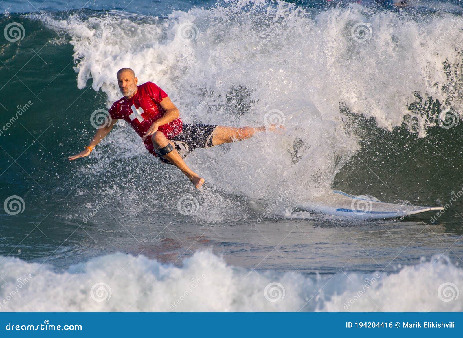 Surfer surfing with waves editorial photo. Image of winter 194204416