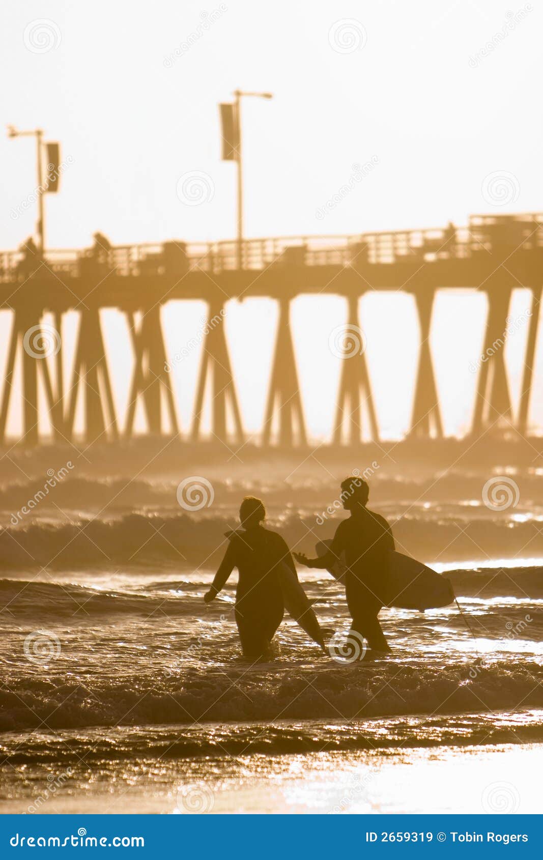 Surfers Near Pier stock image. Image of surfboard, waves 2659319