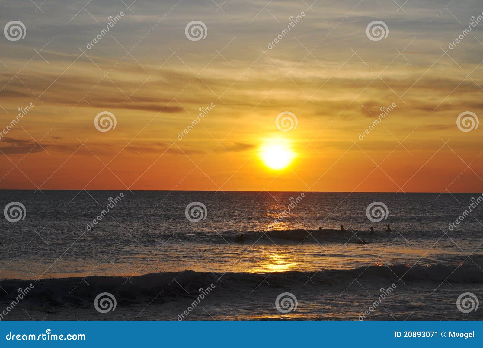 surfers at sunset