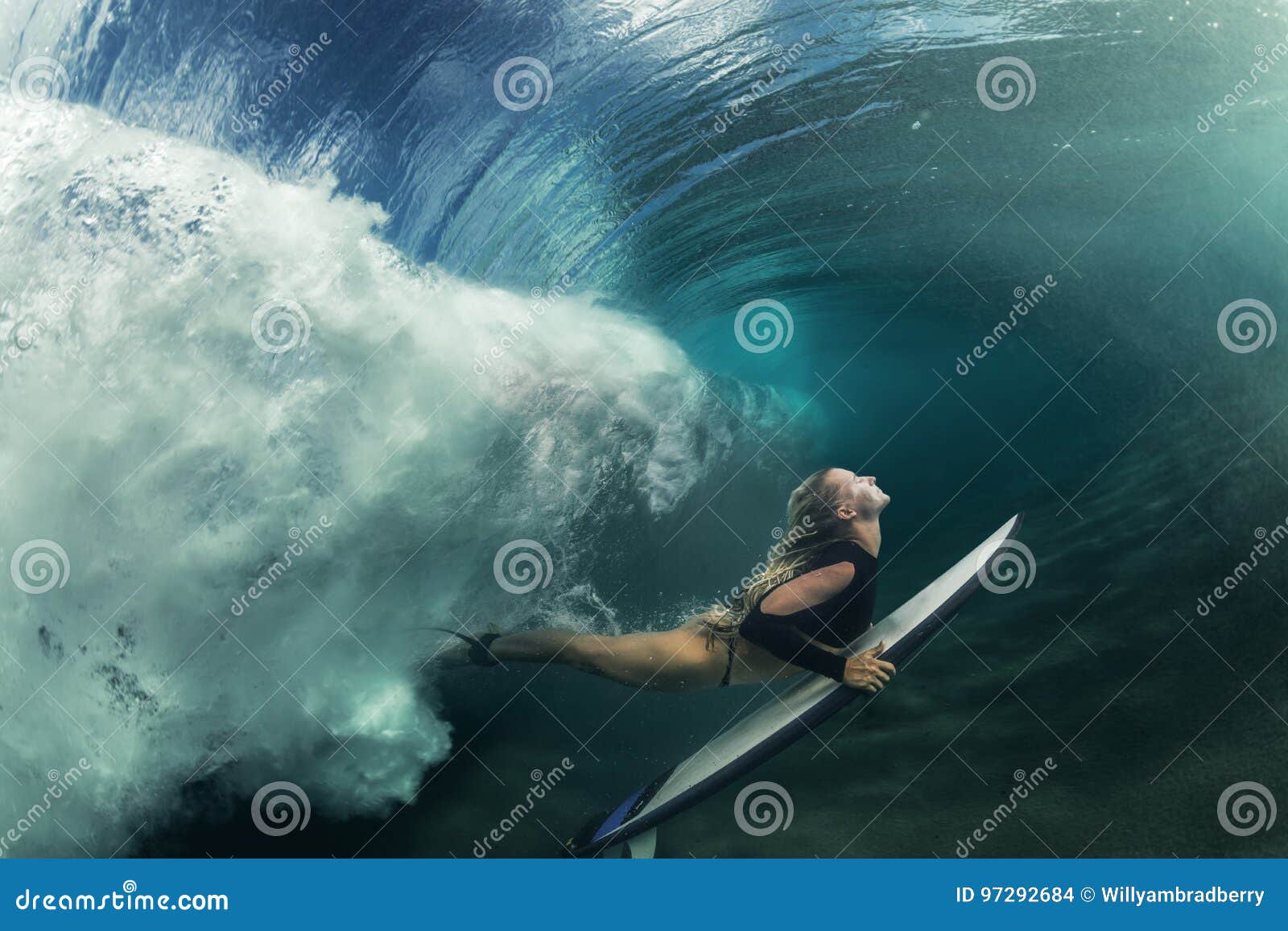 surfing girl having fun under wave