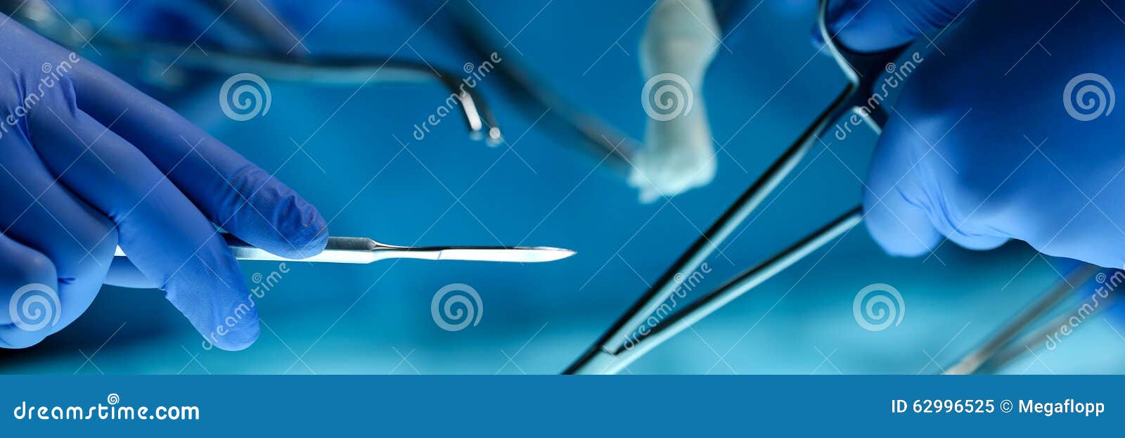 surgeons hands holding surgical instrument