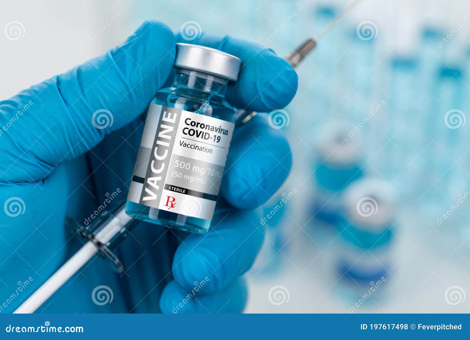 surgical glove holding coronavirus covid-19 vaccine vial and syringe