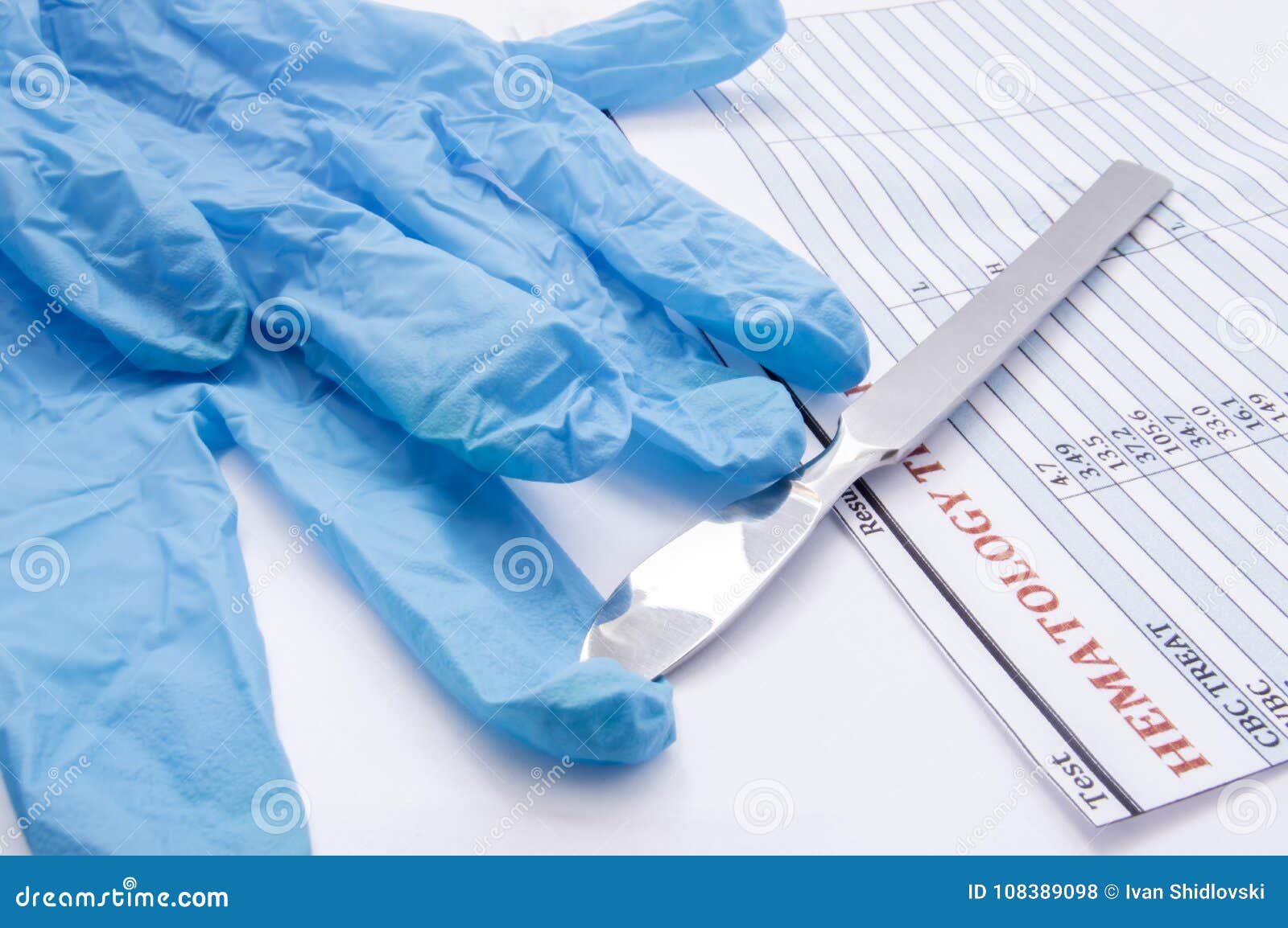 surgical gloves, scalpel and hematology blood test result on operating table. preparation for surgery or its completion. physician