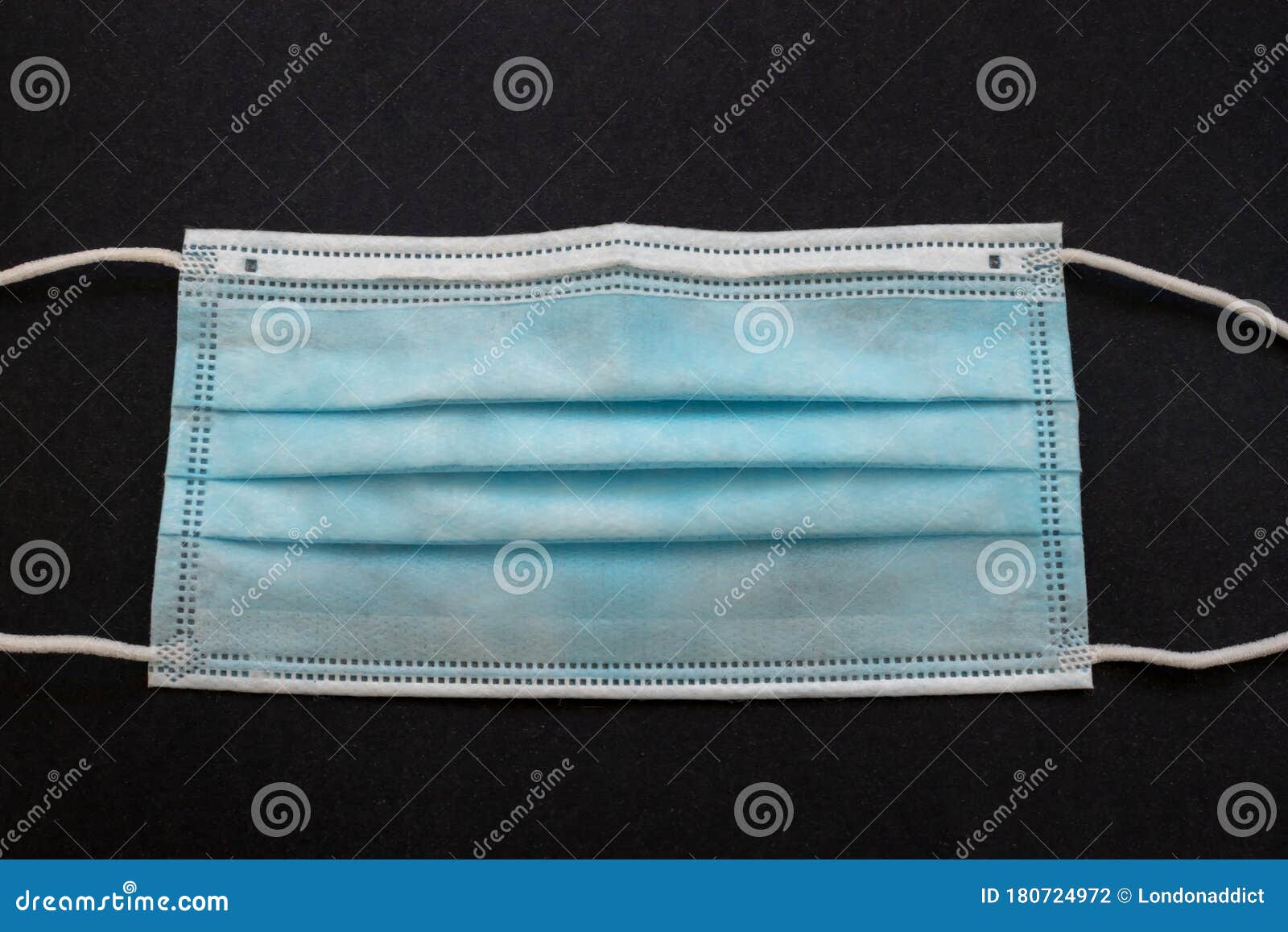 surgical mask with rubber ear straps. typical 3-ply surgical mask, masks pff2 and pff3 against covid. procedure mask from bacteria