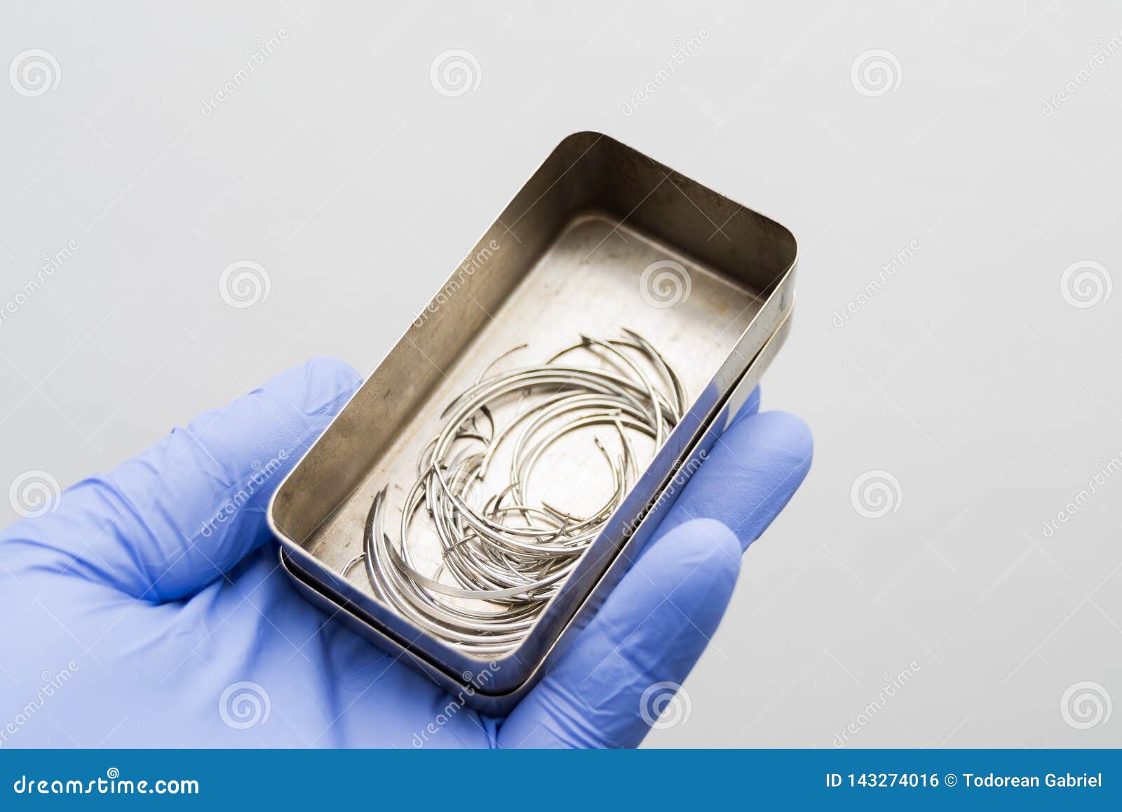 Surgical Needles in the Metal Box in the Hand of Surgeon Stock Photo