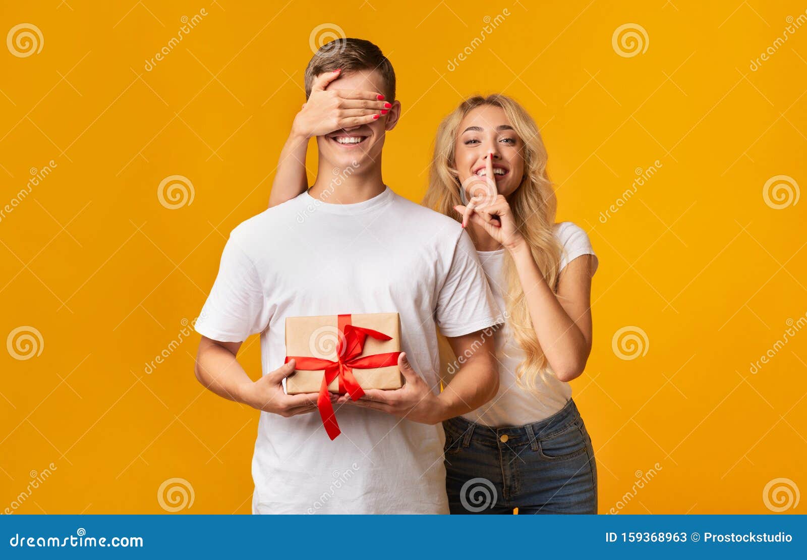 Surprise. Girl Covering Her Boyfriend`s Eyes and Showing Silence Sign ...