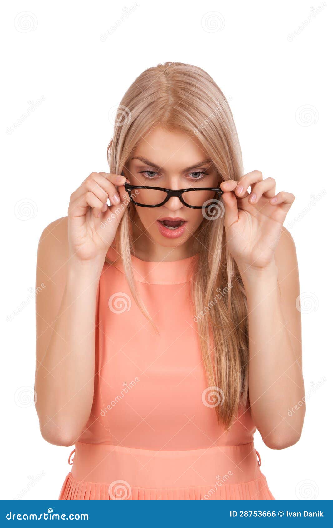 surprised blond woman looking down over glasses