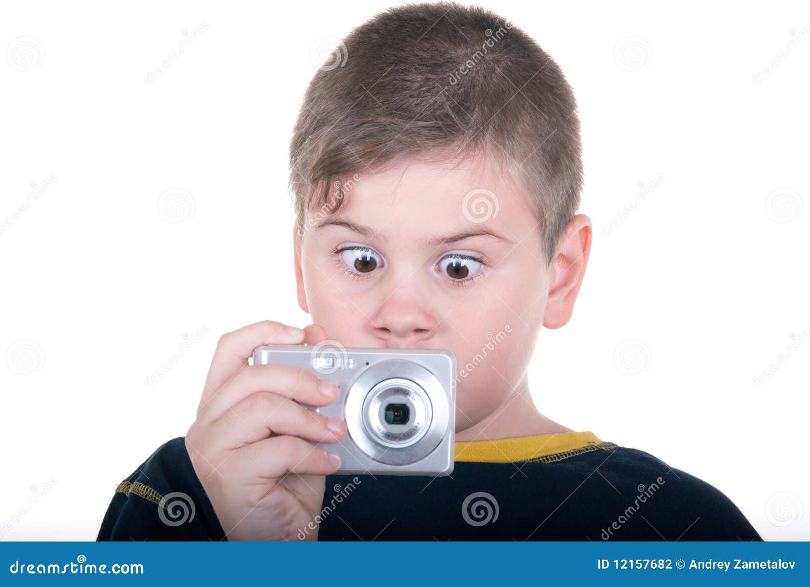 Surprised boy with camera on white background