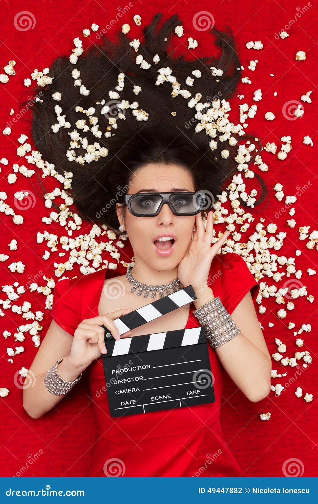 surprised girl with 3d cinema glasses, popcorn director clapboard