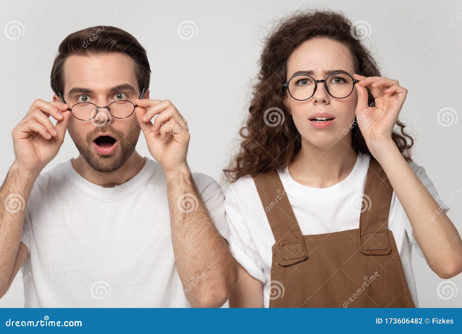 Surprised Happy Millennial Man And Woman Looking Closely At Camera