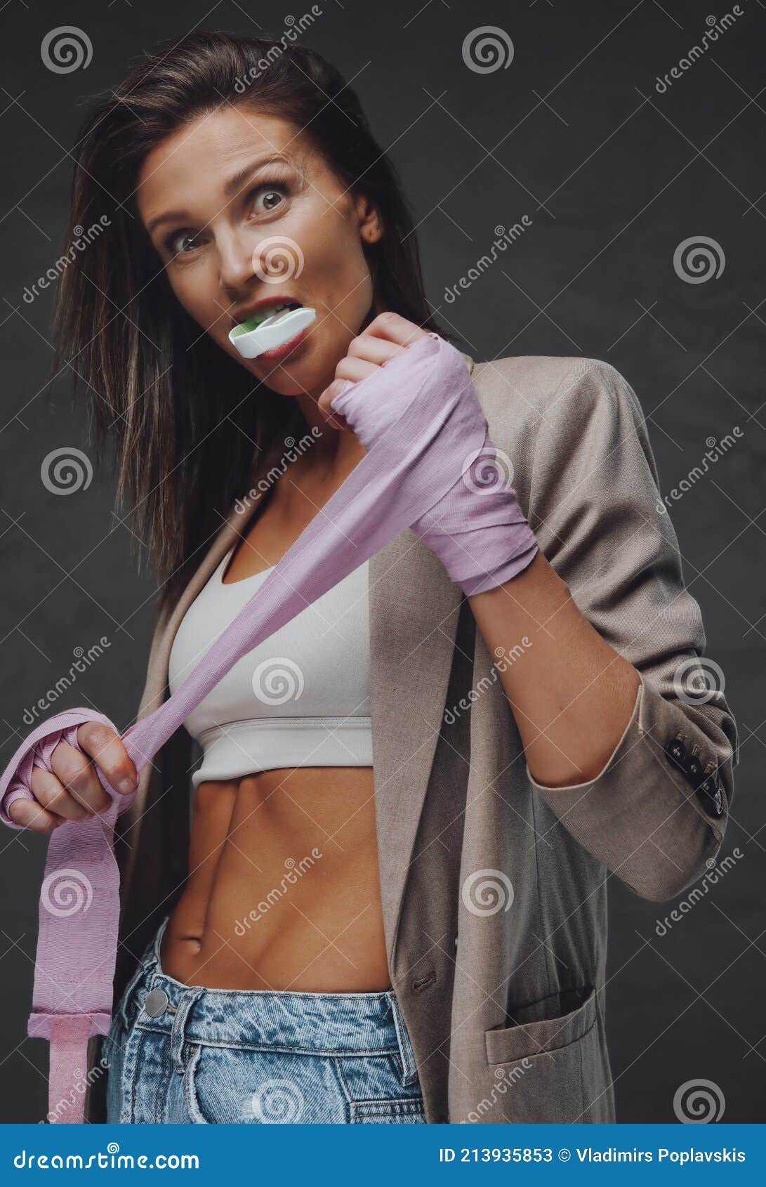 Surprised Sportswoman Pulling Bandage in Dark Background Stock Image -  Image of middleaged, competitive: 213935853
