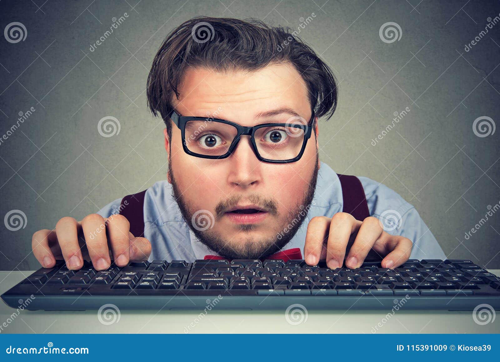 surprised business man typing on key board