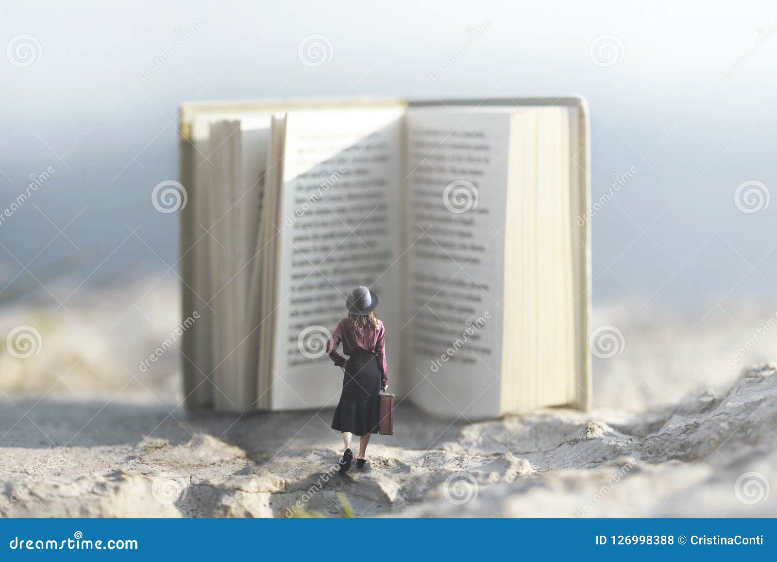 surreal moment of a woman walking towards a giant book