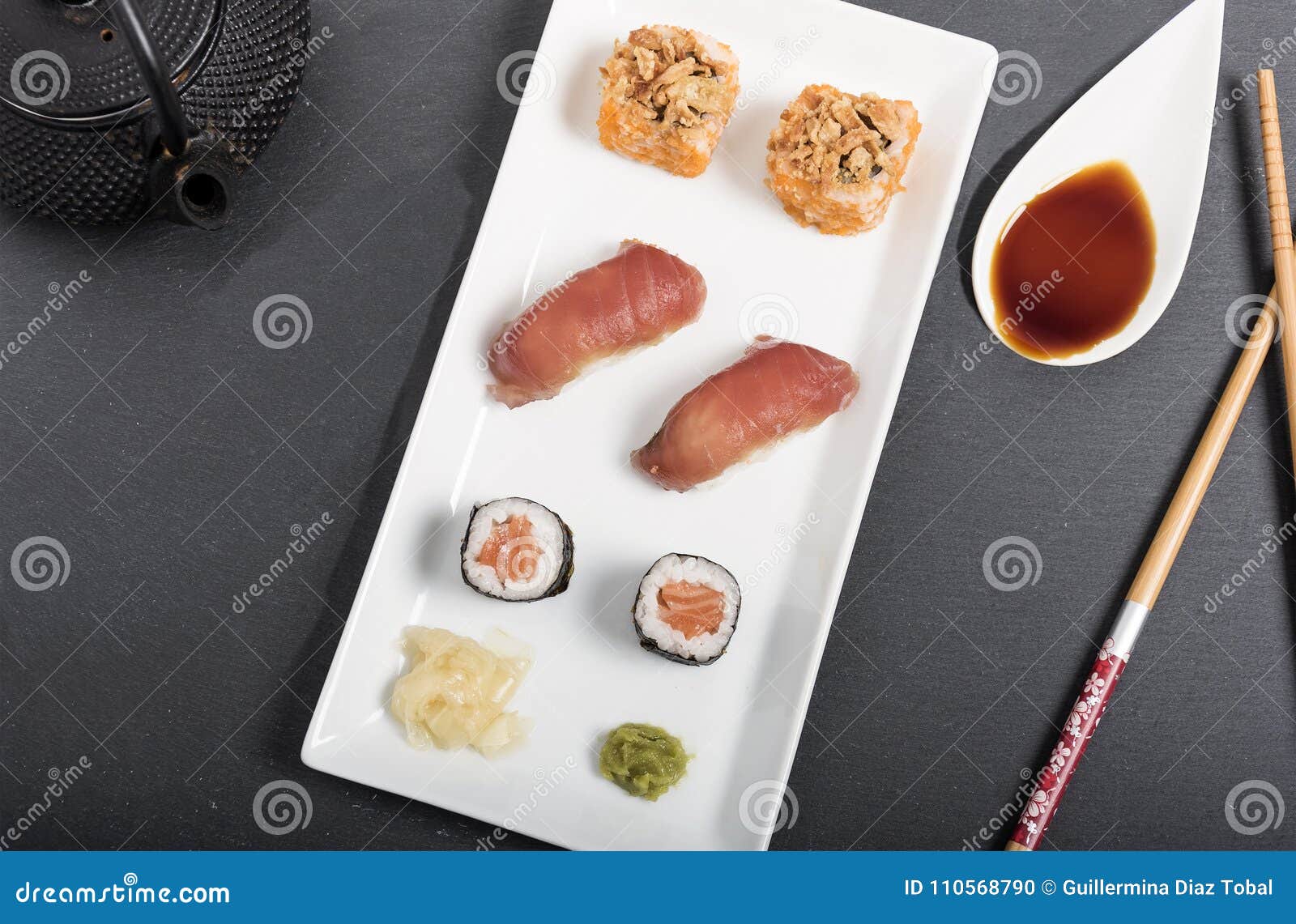 sushi mix with sauces on a white tray