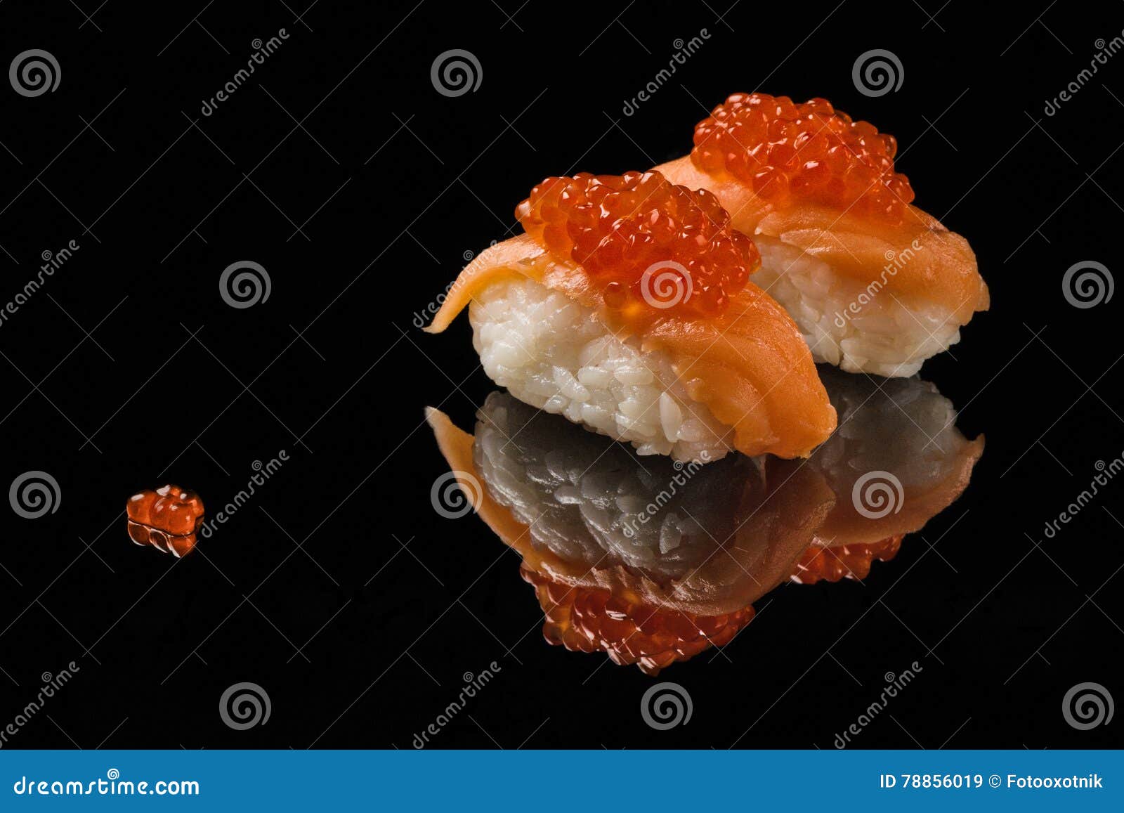 sushi and red caviar on black acryle