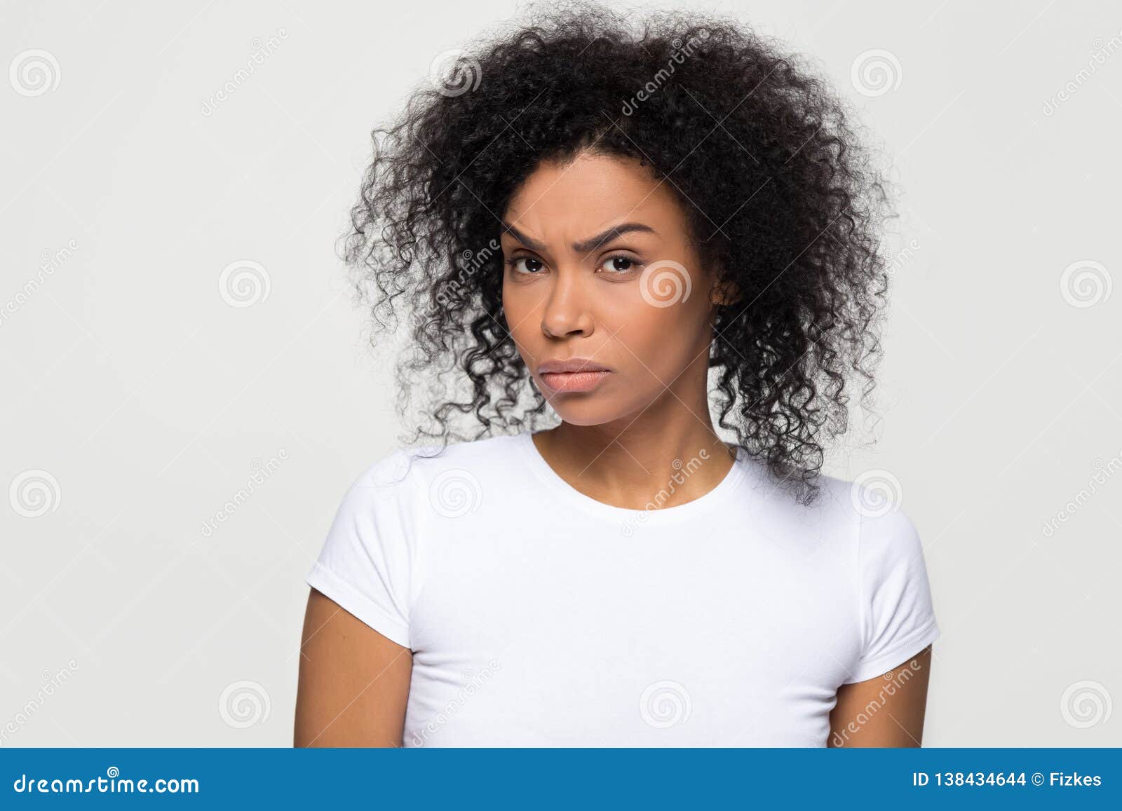 suspicious african woman with distrustful face looking at camera