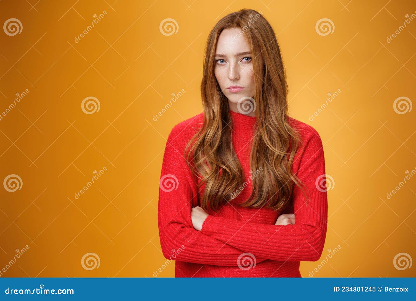 suspicious intense and defensive ginger girl standing in passive-aggressive pose pouting and frowning looking with