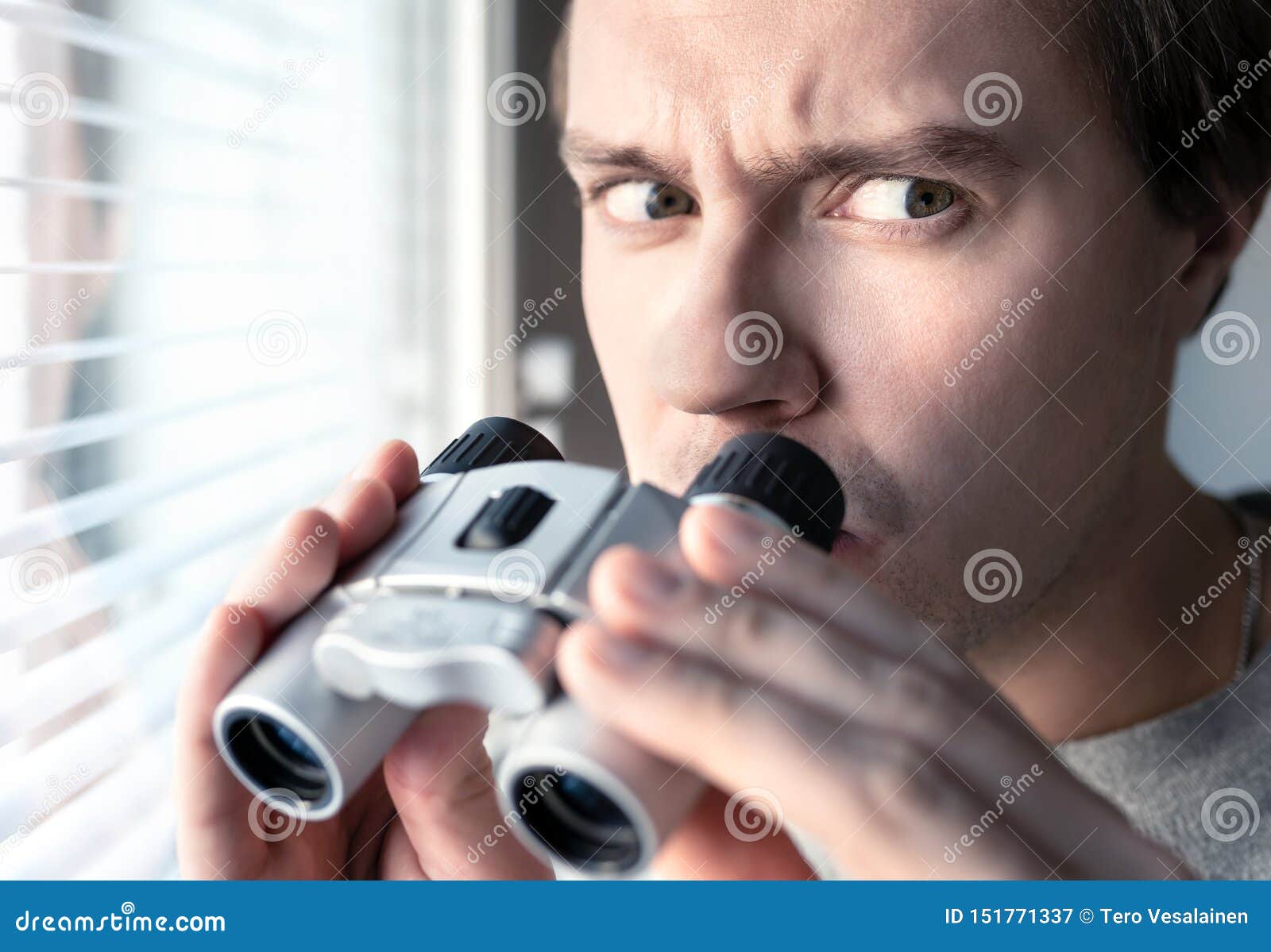 suspicious, skeptic and confused man with binoculars. conspiracy theory, paranoia, skepticism or suspicion concept.