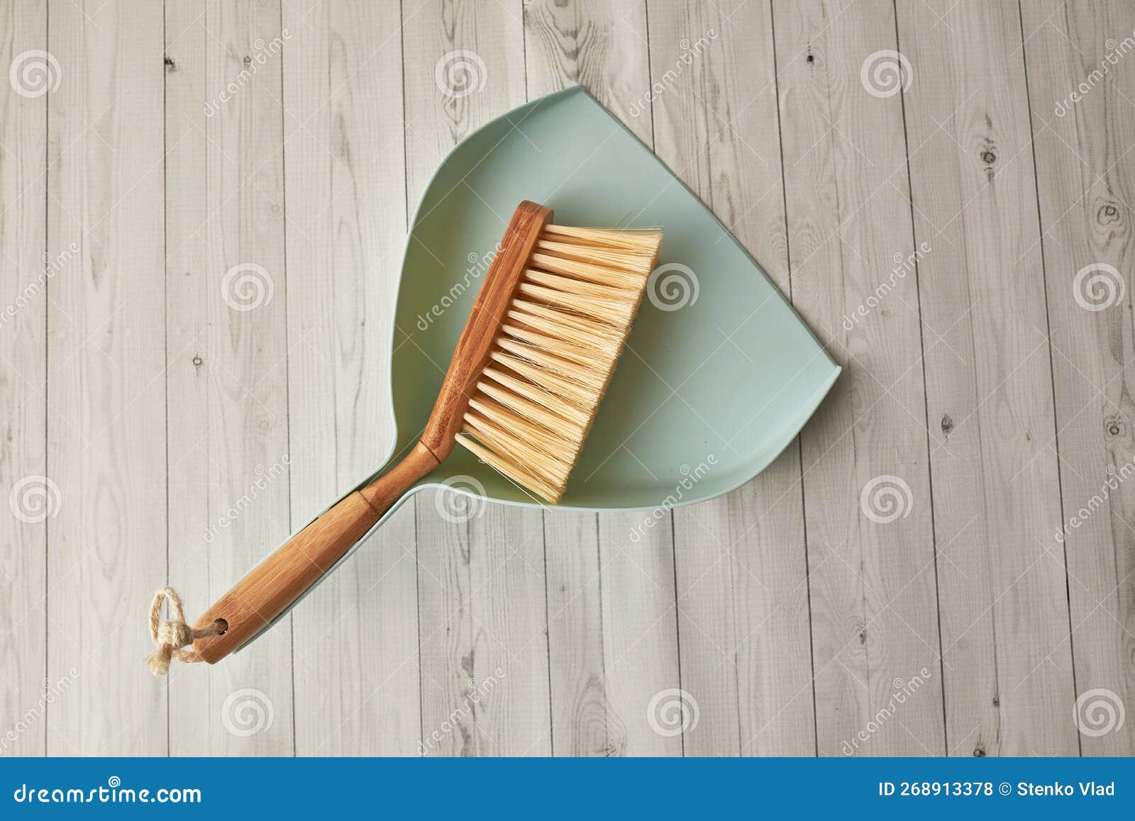 Sweeping Dust with a Broom on a Dustpan, Housekeeping Concept Stock