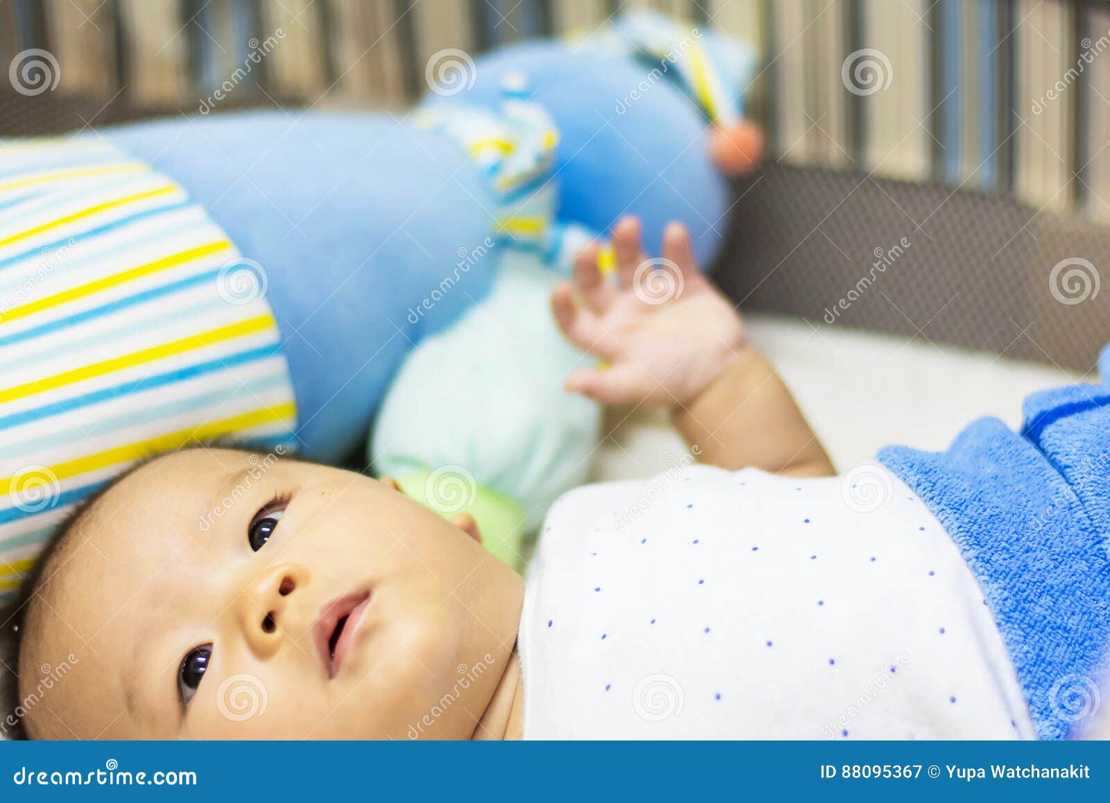 Sweet baby laying on bed stock image. Image of playing 88095367