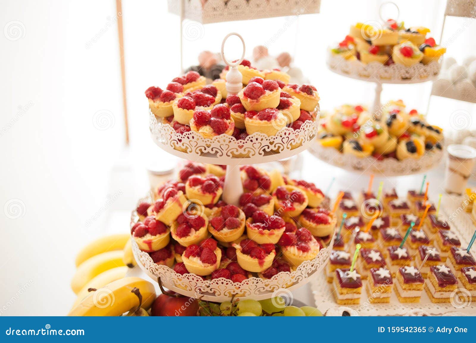 sweet candy bar.different delicious fruits and cakes on wedding reception table .