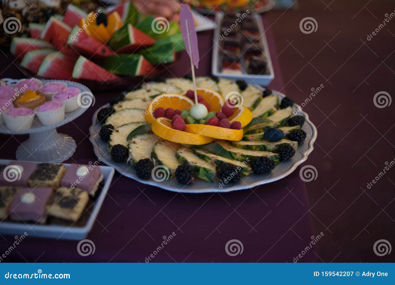 sweet candy bar.different delicious fruits and cookies on wedding reception table with bananas and grapes