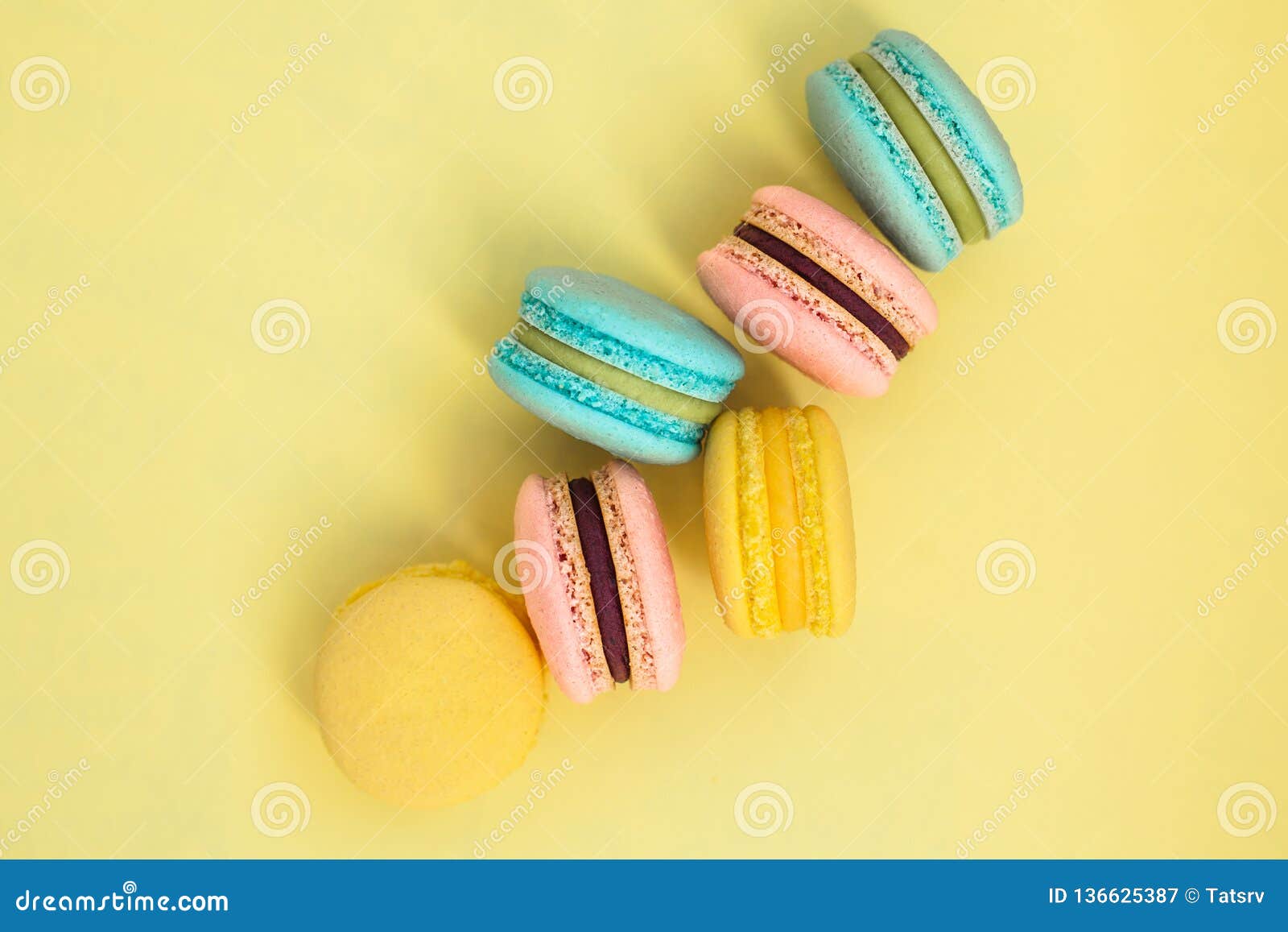 Sweet Colorful French Macaroon Biscuits on Yellow Pastel Background ...
