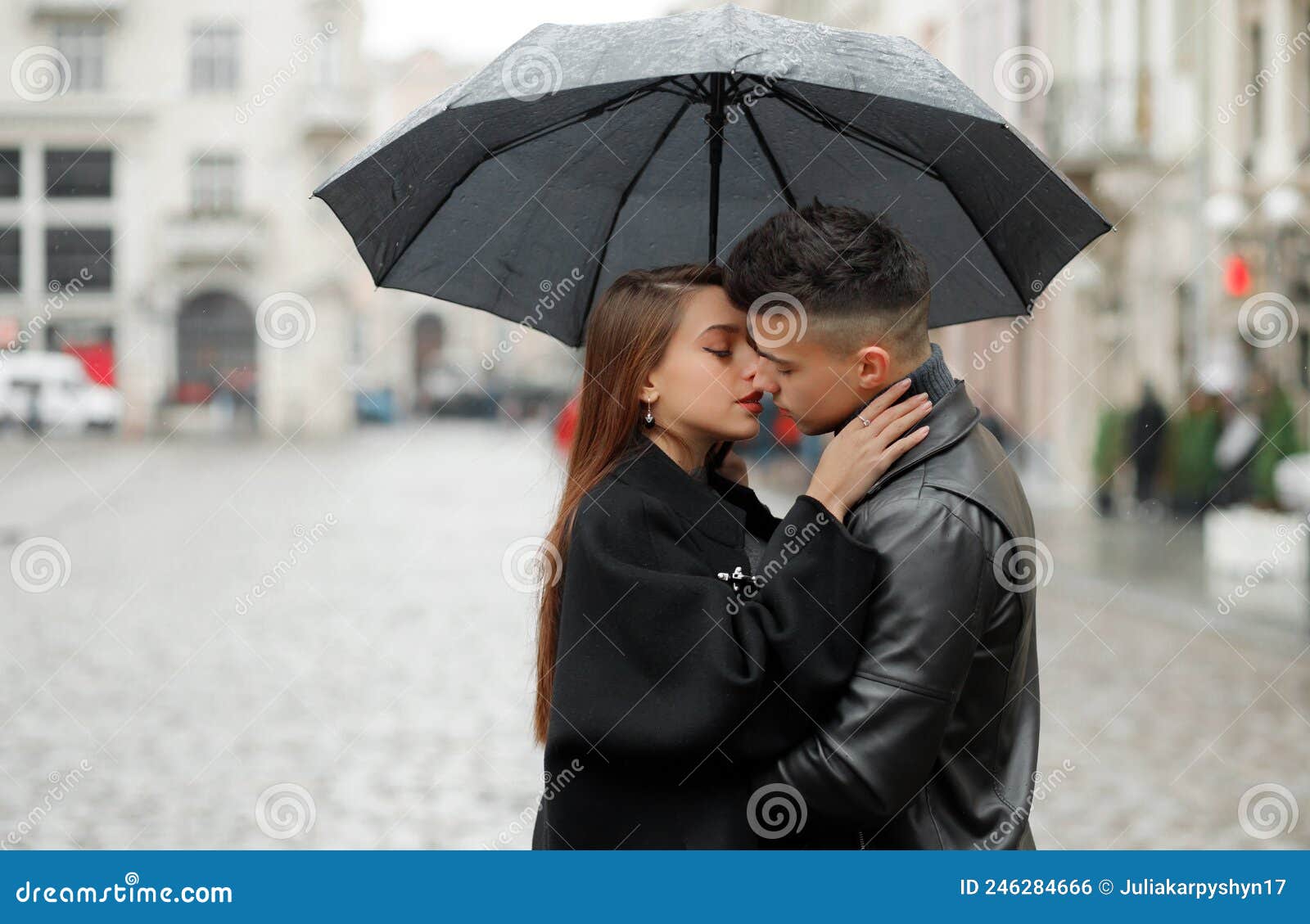 Sweet Couple Boy and Girl Kissing Under an Umbrella in the Rain ...