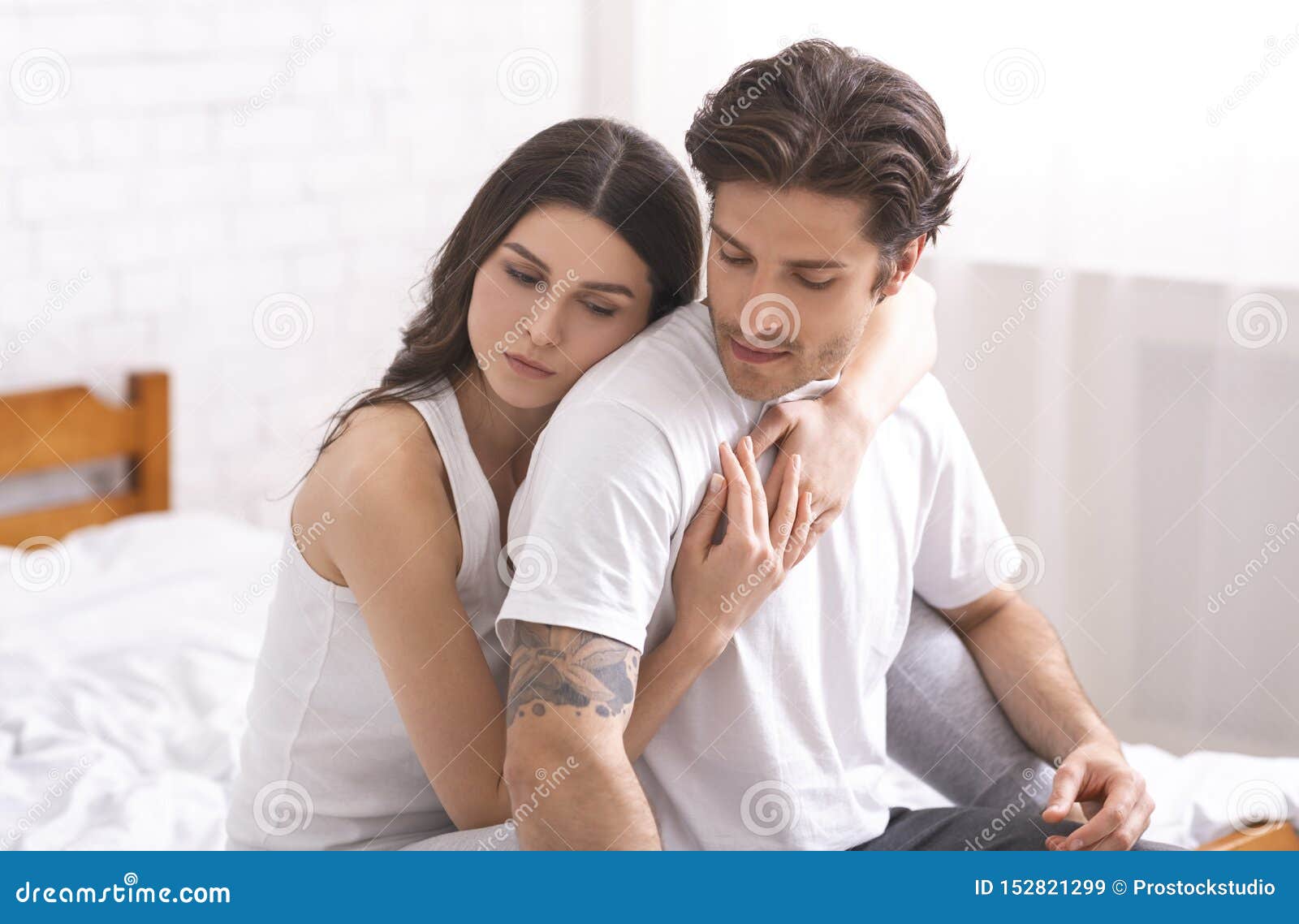 Sweet Couple Embracing in Bedroom, Sitting Together on Bed Stock ...