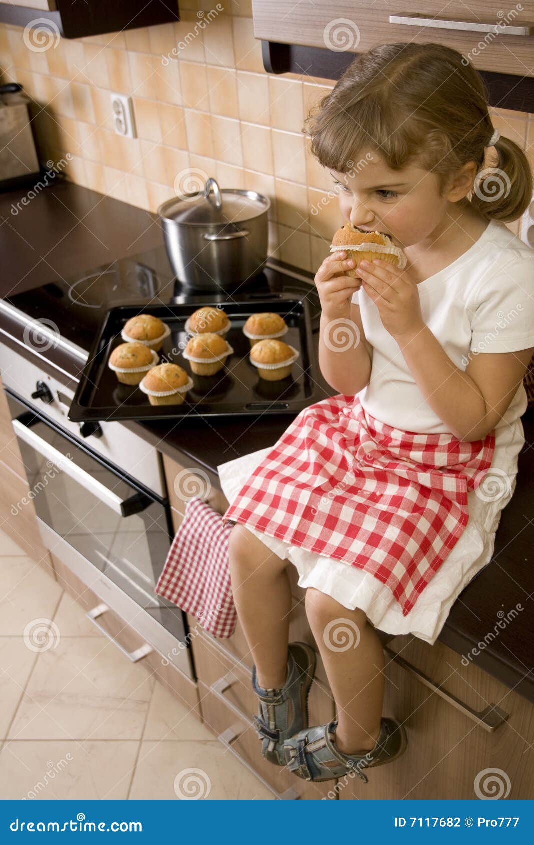 Sweet girl eating muffin stock photo. Image of child, house 7117682