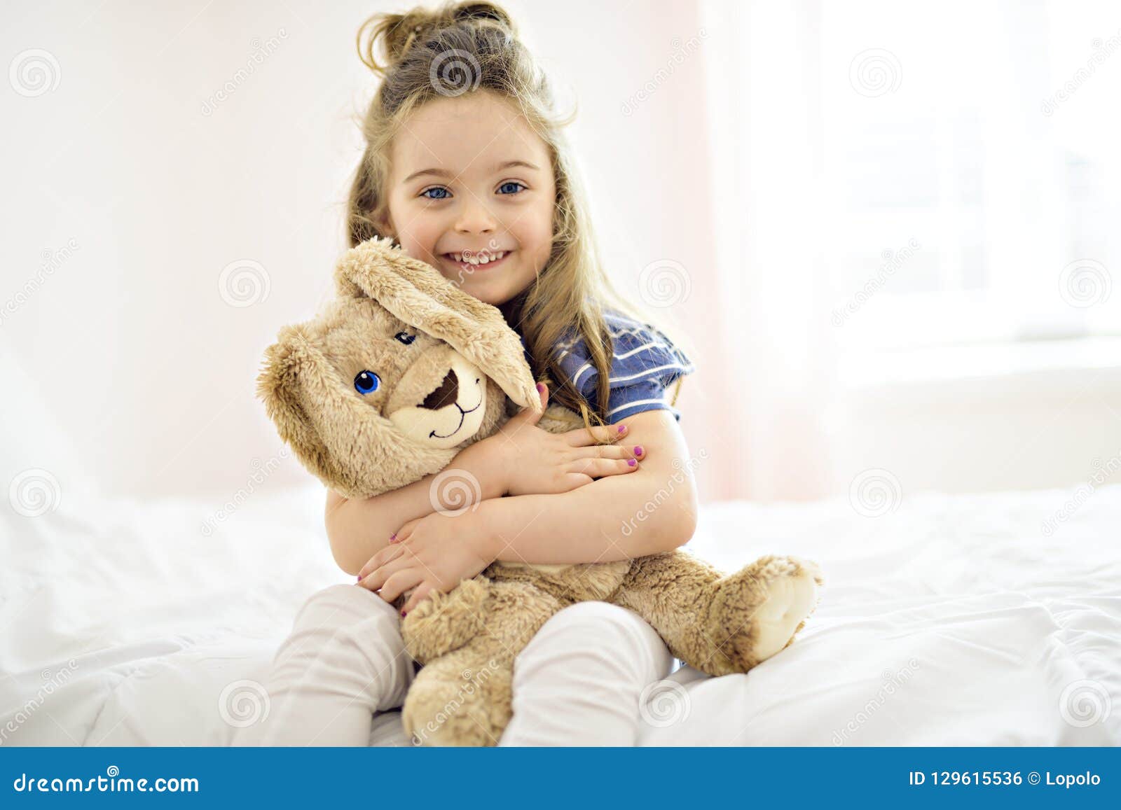 Sweet Little Girl is Hugging a Teddy Bear on Her Bed at Home Stock ...