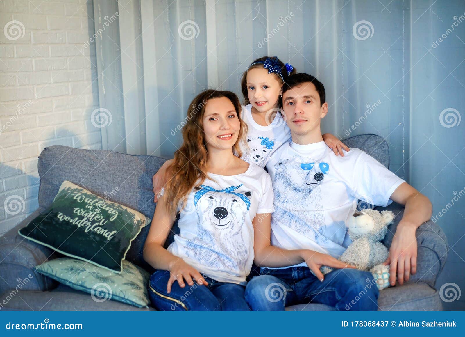 Sweet Little Girl Together With Beautiful Young Mom And Dad Sitting On