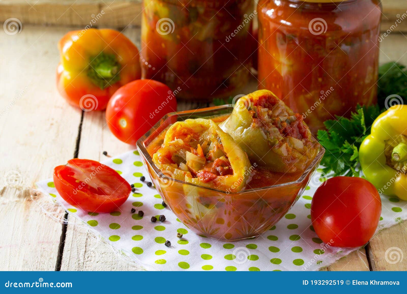 sweet pepper to stuff vegetabless in tomato sauce on the kitchen wooden background.