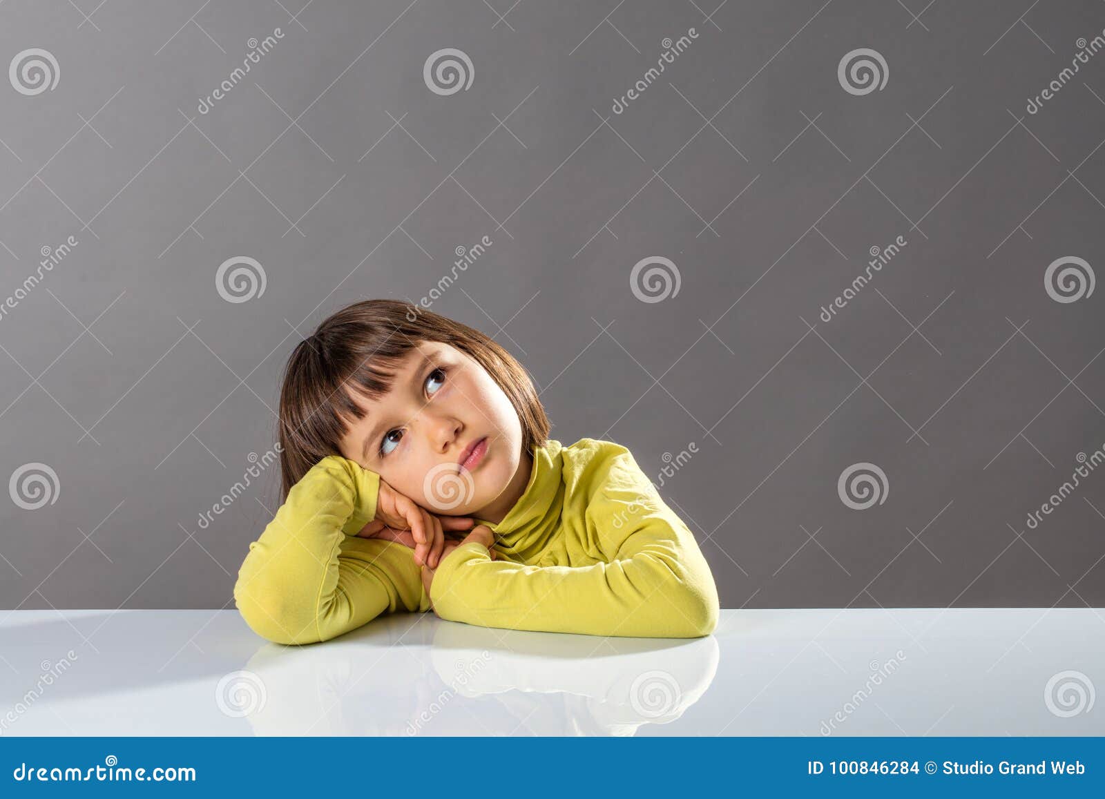 sweet pouting thinker looking away for concept of kid boredom