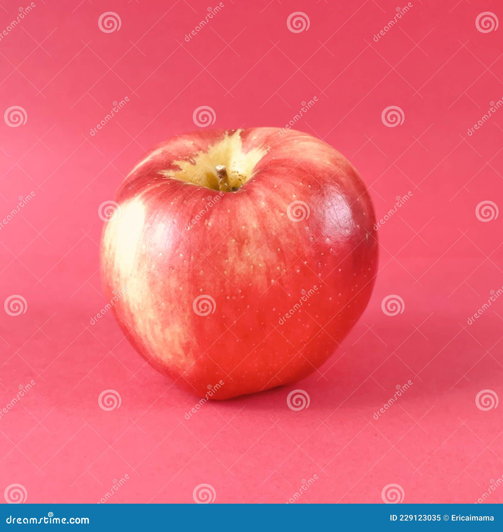 an apple on red color background.