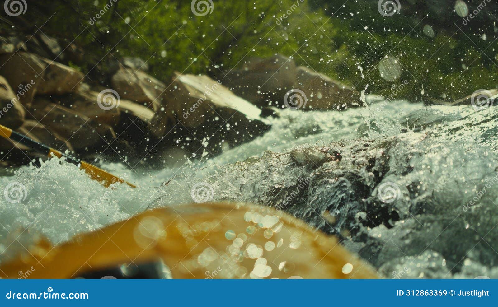 a swift current rushes over boulders in a surging rapid creating a misty spray that adds to the excitement of the