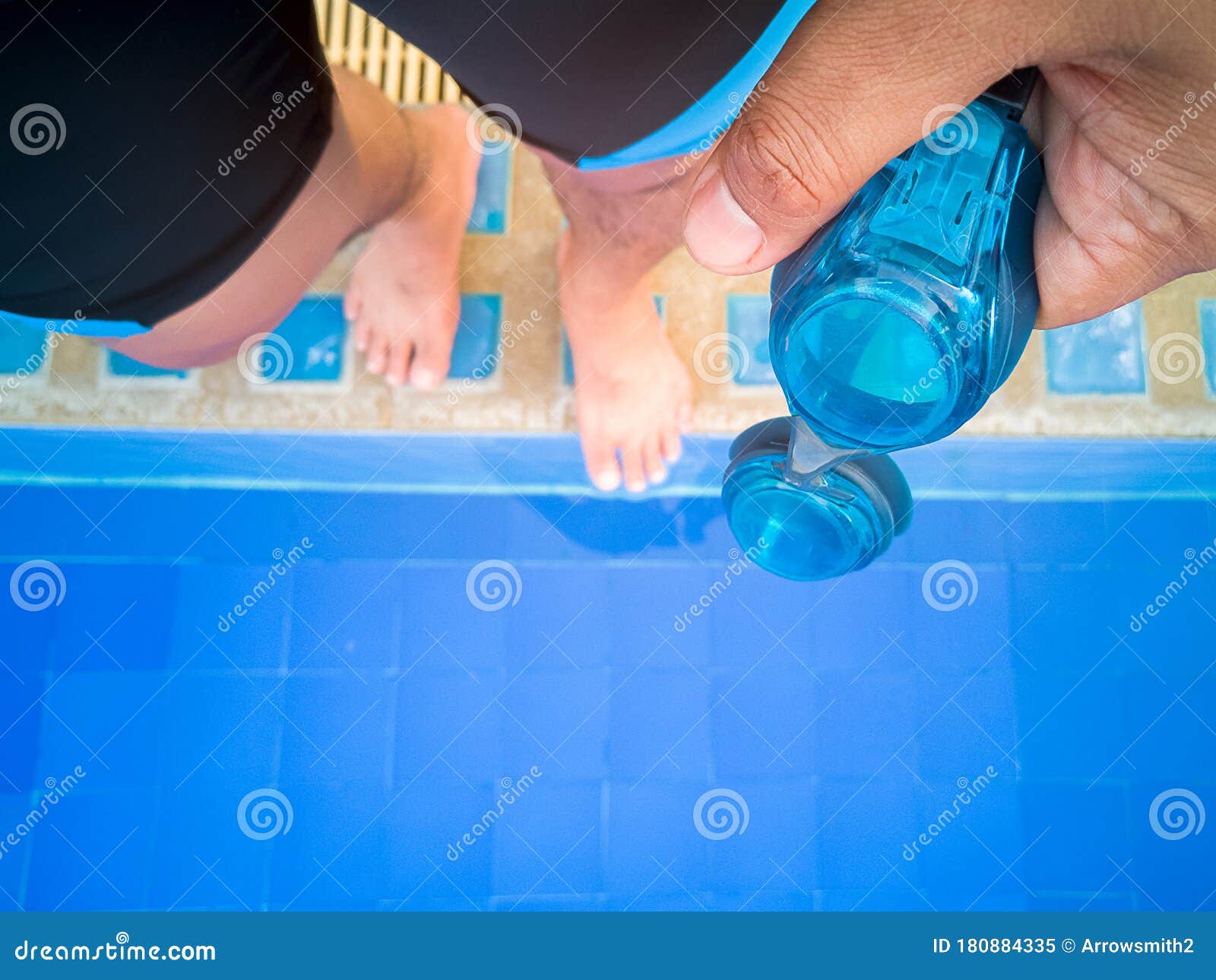 Swimmer `s Hand Holds the Swimming Goggles on the Pool Edge Stock Image