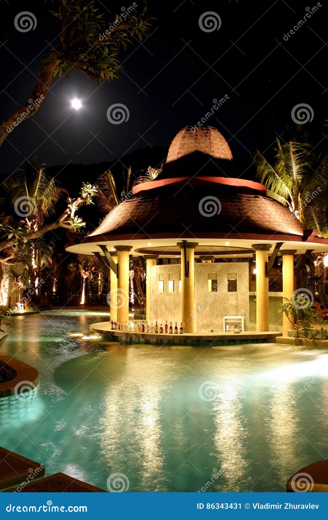 Swimming Pool Sun Loungers Near To The Garden Under Moon In The