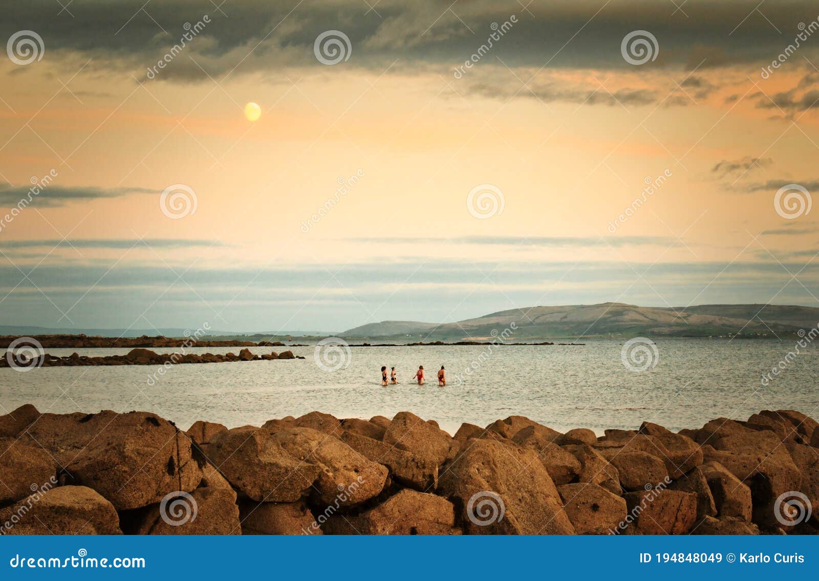 Swimming Under Moonlight at Silverstrand Beach in Galway, Ireland Stock