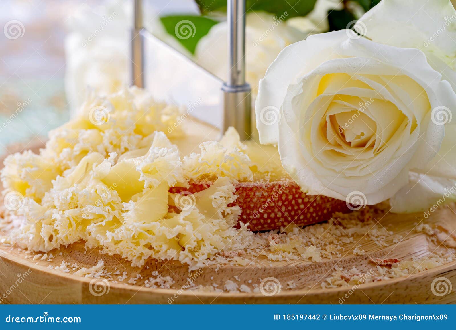 Swiss Cheese with Crumbs on a Wooden Surface and a Decorative Tablecloth  and Beautiful White Roses. Soft Focus. Stock Image - Image of cracks, blue:  190468939